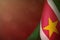 Suriname flag for honour of veterans day or memorial day. Glory to the Suriname heroes of war concept on red dark velvet