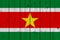 Suriname flag painted on old wood plank