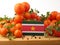 Suriname flag on a wooden panel with tomatoes isolated on a whit