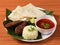 Surmai Fish thali from an indian cuisine, consists of fish fry, steamed rice, lentils and roti, selective focus