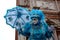 Surprise, a blue mask with umbrella at the Venice carnival