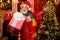 Surprise concept. Santa Claus delivering gift. Delivery service. Gift shop. Man senior Santa claus hold gift box. Winter