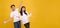 Surprise young Asian couple man and woman happy and amazed on panoramic yellow background