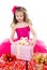 Surprised adorable little girl with christmas gift boxes