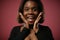 Surprised afro girl on red background in black t-shirt