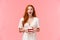 Surprised and amused charismatic redhead girl gossiping during party, holding plate with cake and open mouth fascinated