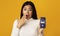 Surprised Asian Woman Holding Smartphone With Opened Voice Translation App On Screen