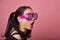 Surprised asian woman, Shocking girl wearing funny glasses on isolated pink background.