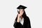 Surprised bachelor girl in graduation robe and cap on white background. Happy and funny young woman smile. Student