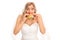 Surprised blond bride eating a sandwich