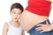 Surprised boy listening pregnant mother belly