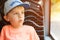 Surprised boy looking out window of bus. Cute little boy in cap sitting in bus. Travel, lifestyle and people concept. Summer holod