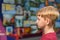 A surprised boy looks at paintings in an exhibition gallery