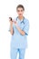 Surprised brown haired nurse in blue scrubs using a mobile phone