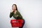 Surprised brunette woman holding empty shopping basket