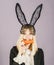 Surprised bunny woman wearing bunny ears and eat carrot. Happy easter and funny easter day. Smile easter.