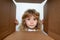 The surprised child unpacking, opening carton box and looking inside. The package, delivery, surprise, kids gift concept