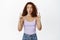Surprised curly redhead woman, gasp and look excited, pointing fingers up at awesome promo deal, sale banner, standing