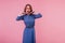 Surprised cute girl in vintage attire posing on pink background. Studio photo of fascinating curly