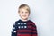 Surprised, enthusiastic child in a sweater with an American flag on a white background