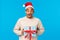 Surprised enthusiastic and overwhelmed african-american cute man in santa hat, christmas outfit, holding new year gift