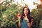 Surprised Farm Girl Holding a Tomato inside a Greenhouse