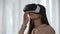 Surprised female playing a video game in virtual reality, spinning head in VR