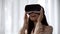 Surprised female playing video game in virtual reality, spinning head in VR