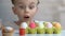 Surprised girl appearing from under table and looking at colorful Easter eggs