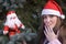 Surprised girl with Santa doll