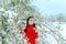 Surprised Girl By Snow Covering Spring Flowers in Blossoming Tree