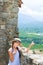 Surprised Girl in straw hat near ancient wall in Eus, France