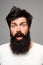 Surprised handsome man. Shocked male model with surprise expression, wow amazed excited face. Barber with long beard and