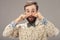 Surprised happy man with beard and moustache looking sideways in excitement, isolated on gray background