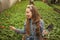 surprised happy teen girl florist care pot plants in greenhouse, gardener