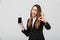 Surprised lady showing ok gesture and smartphone isolated