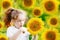 Surprised little girl hold the head sunflower. Healthcare, medic