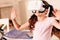 Surprised little girl trying on virtual reality goggles