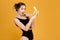 Surprised lovely cute young woman in black swimwear holding banana
