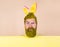 Surprised man with bunny ears with advertising board. Happy Easter day. Bearded man with yellow dyed hair and beard.