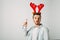 Surprised man in red christmas hat over grey background