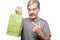 Surprised mature man holding shopping bag isolated on white