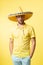 surprised mexican man in sombrero isolated on yellow. mexican man in sombrero on background.