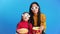 Surprised mother and her little daughter in 3D glasses with popcorn watching movie
