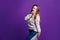 Surprised plus size model in casual clothes, fat woman on purple background
