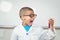 Surprised pupil with lab coat looking at test tube