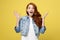 Surprised red hair teenage girl show shocking expression with something. Isolated on Bright Yellow Background. Copy