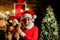 Surprised Santa Claus with teddy bear. Bearded man in Santa Claus costume with teddy bear in room decorated for