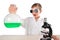 Surprised scientist boy in black glasses holds a flask in his hand