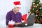 Surprised Senior santa claus man using computer